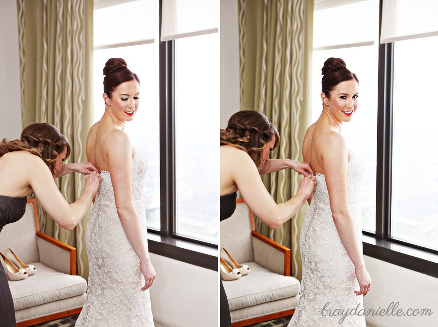 putting on wedding dress