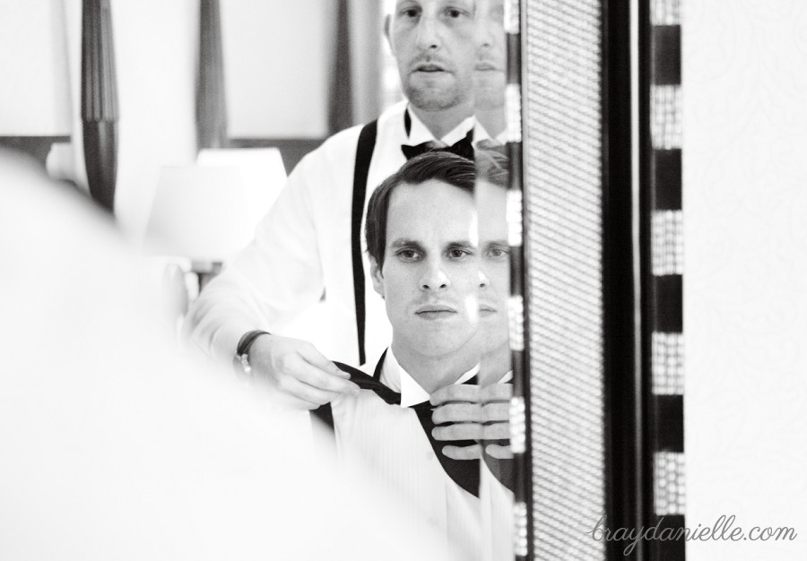 groom tying tie