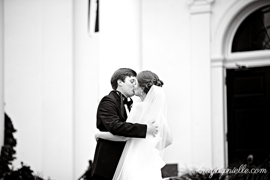 bride and groom kissing during first look