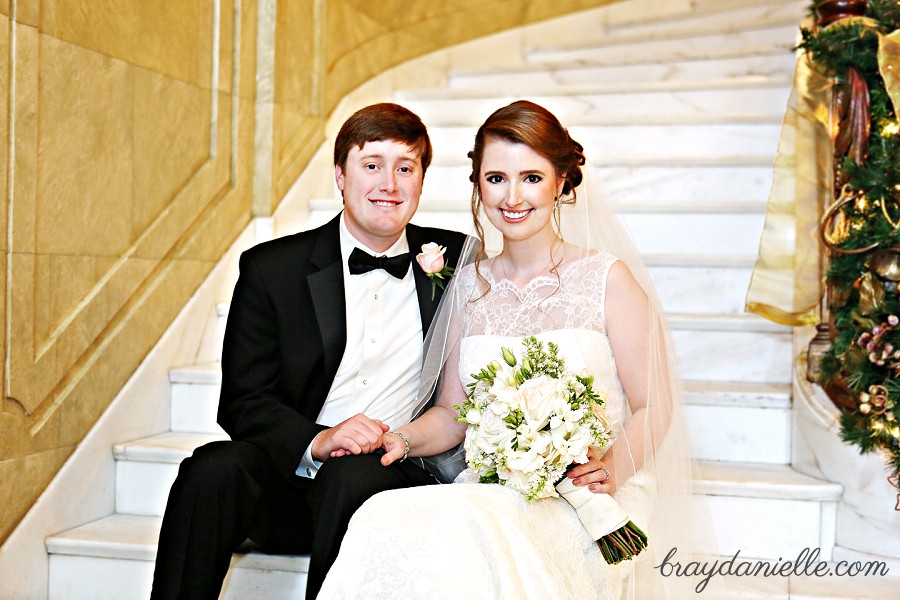 bride and groom sitting on staircase