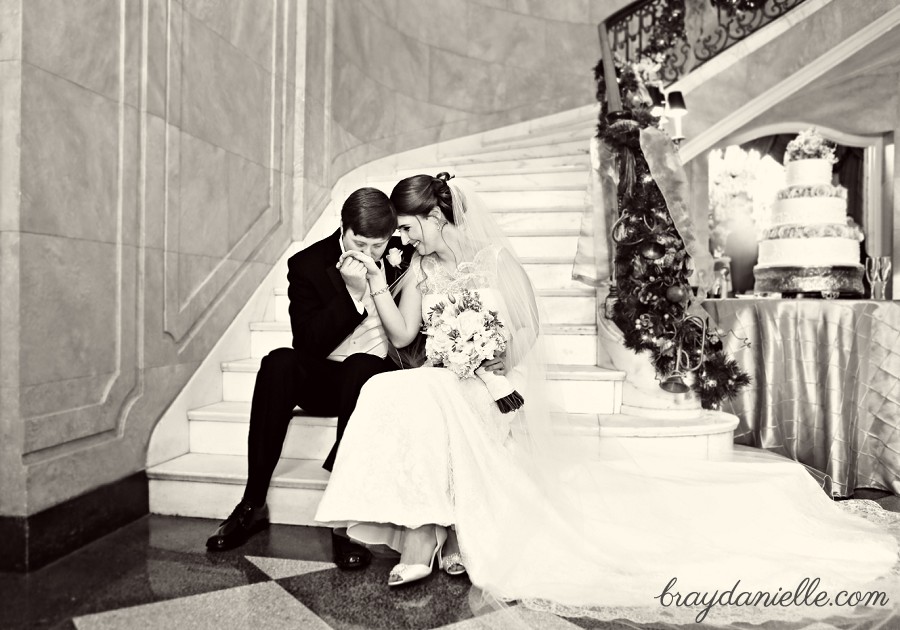 bride and groom sitting on staircase