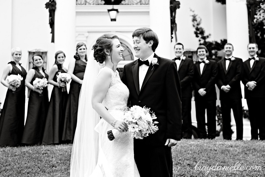 bride and groom in front of wedding party