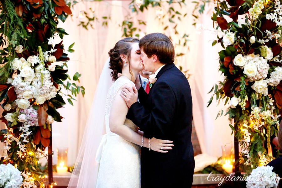 bride and groom first kiss