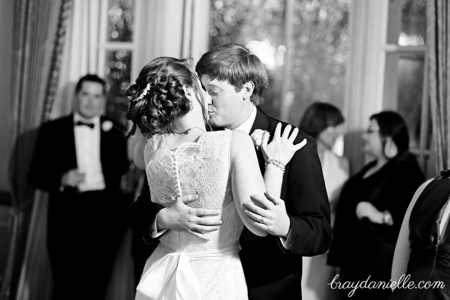 bride and groom kissing while dancing