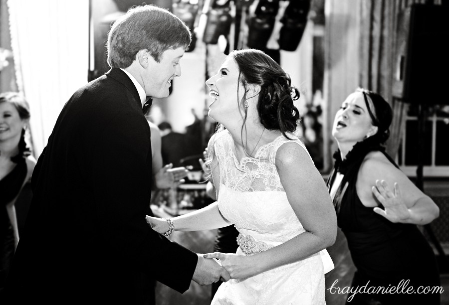 fun bride and groom dancing photo