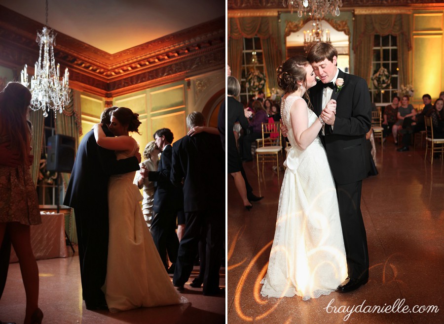bride and groom dancing under chandelier
