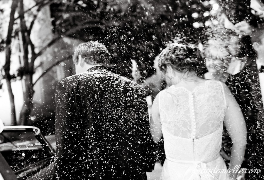 bride and groom excit with snow