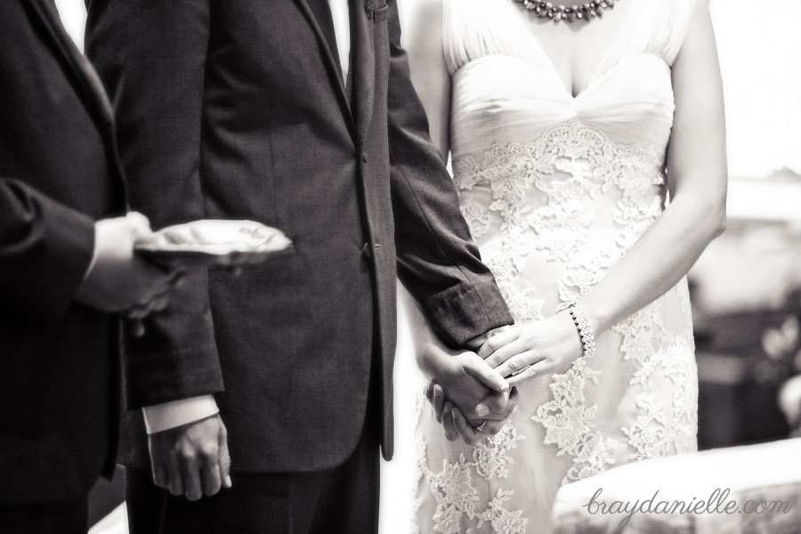 bride and groom holding hands during ceremony