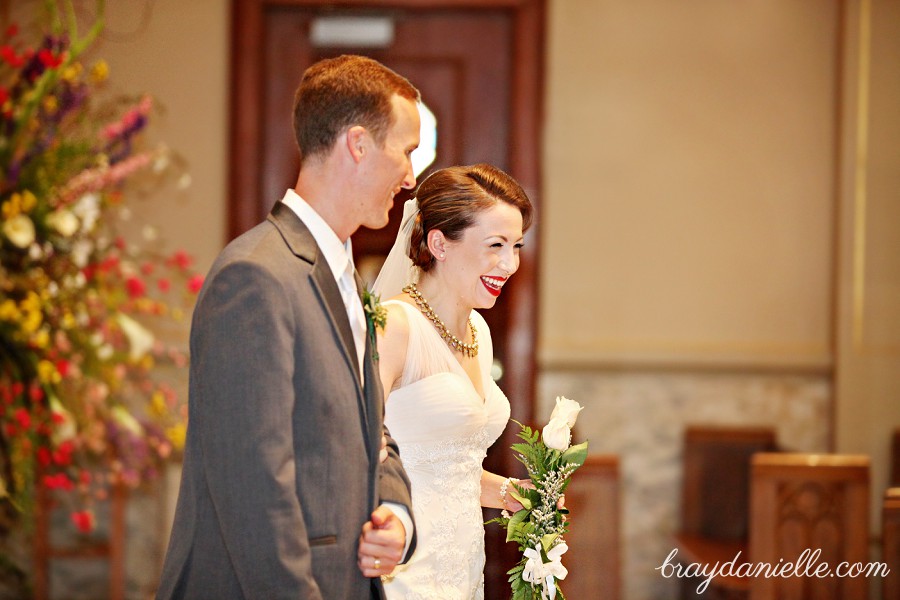 Bride and groom giving out roses