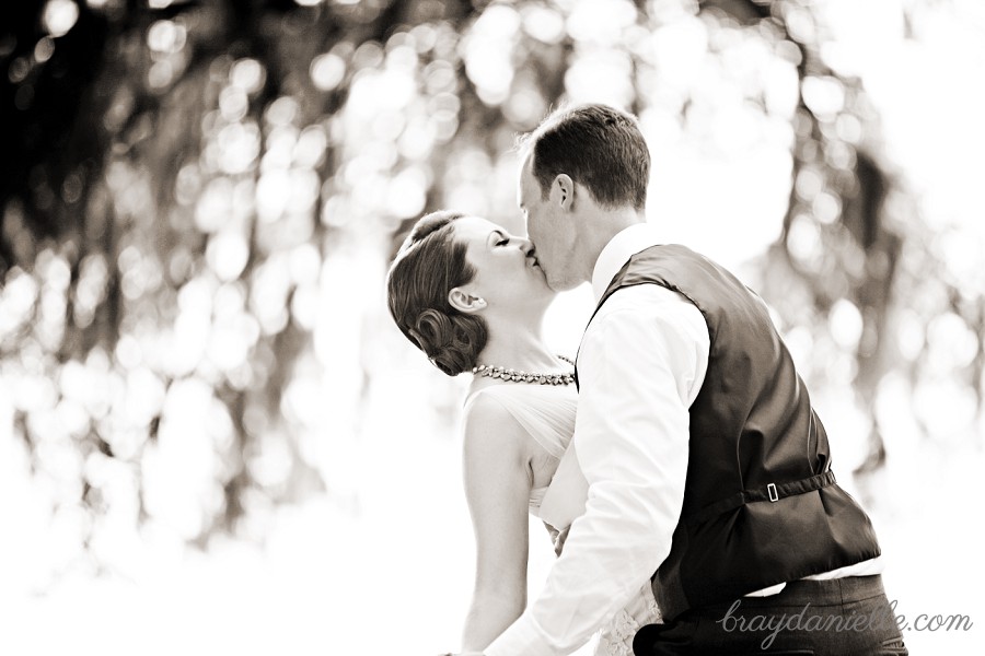 Outdoor bride and groom kiss
