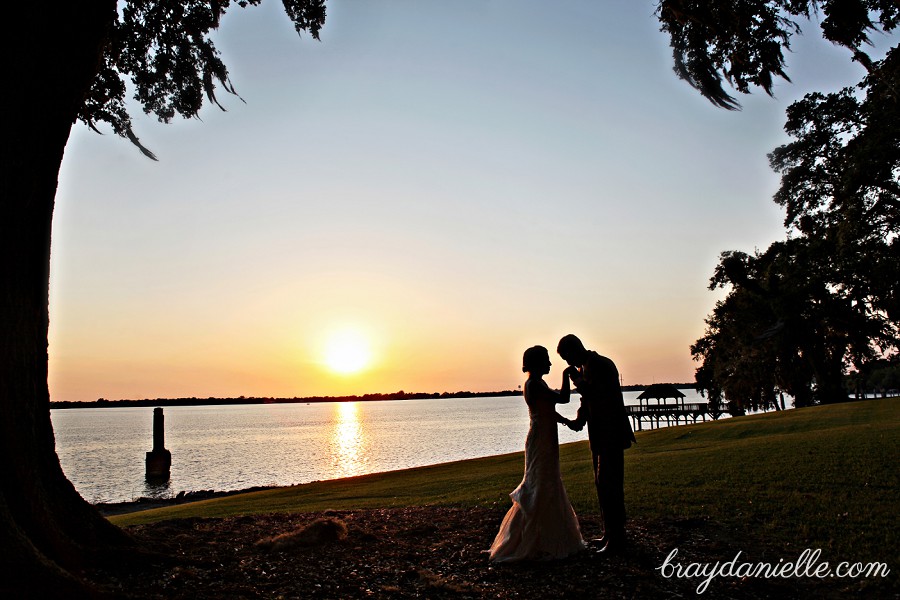 Romantic silhouette of bride and groom at sunset