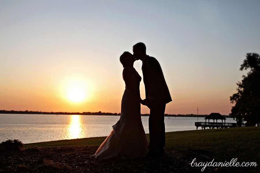 Romantic silhouette of bride and groom at sunset