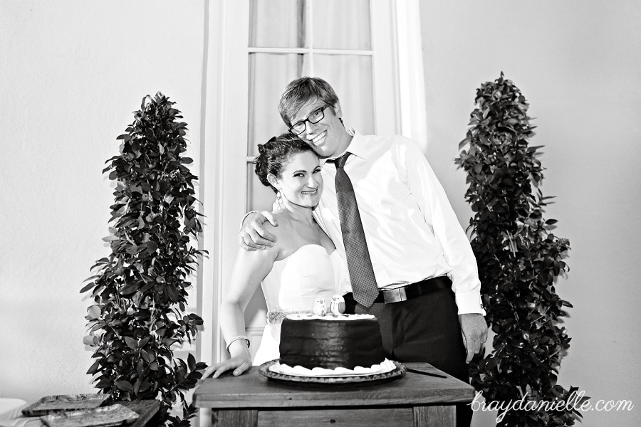 Bride and groom by cake