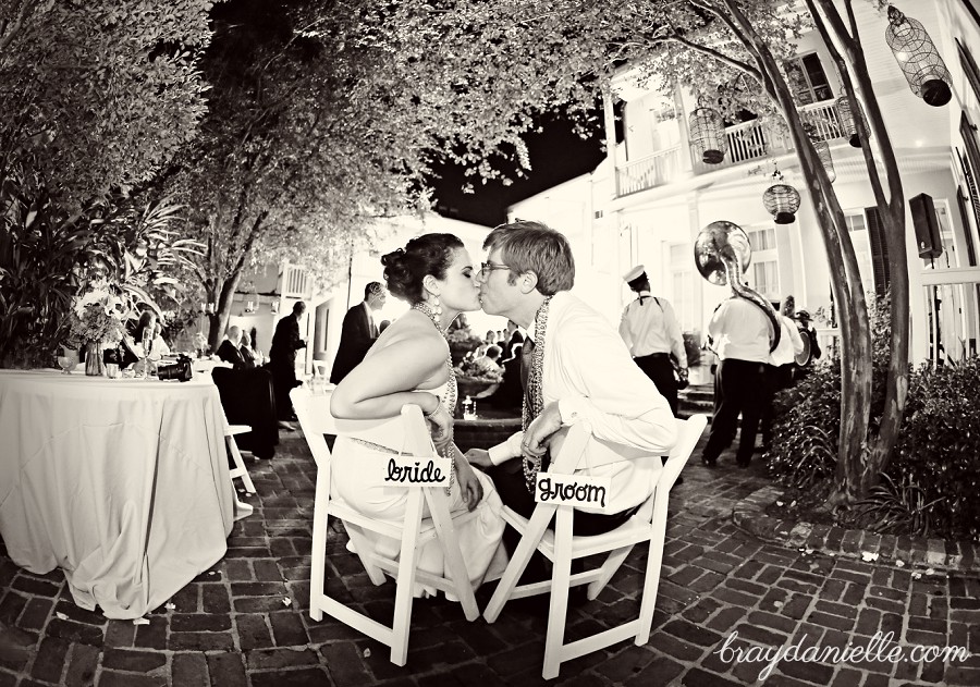 bride and groom kissing while seated