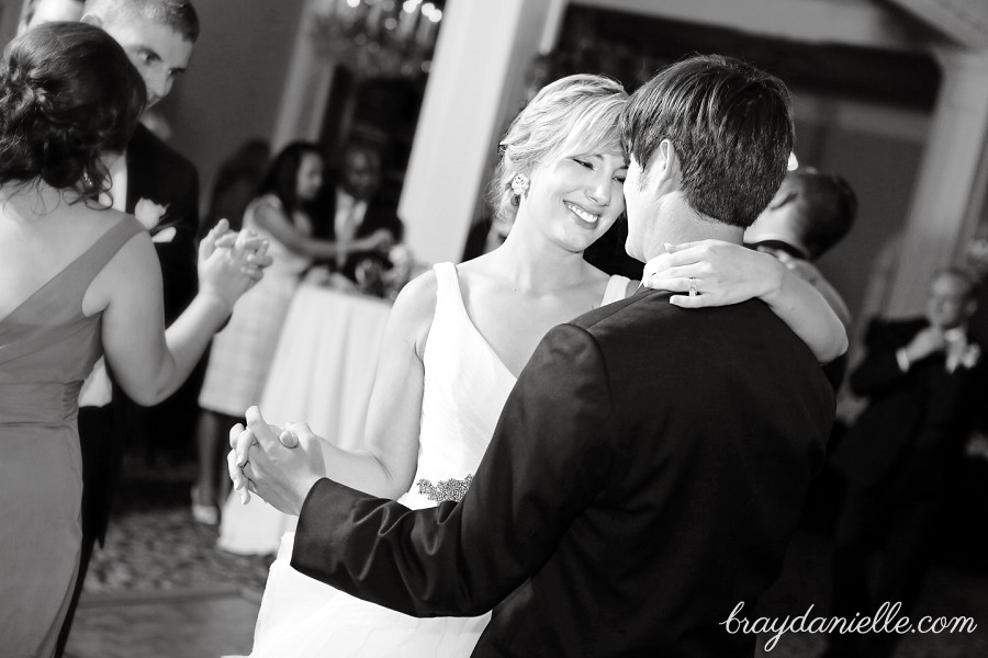 bride smiling at groom while dancing