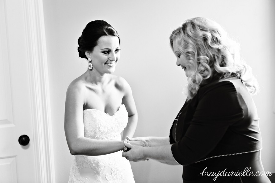 Brides family helping put on jewelry