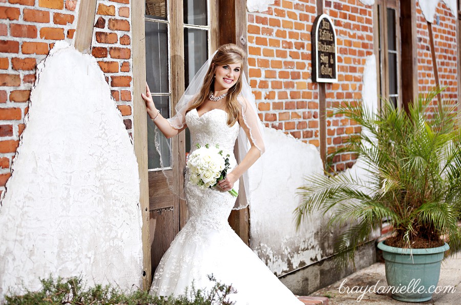 bride near brick wall at white oak plantation by Bray Danielle Photography 
