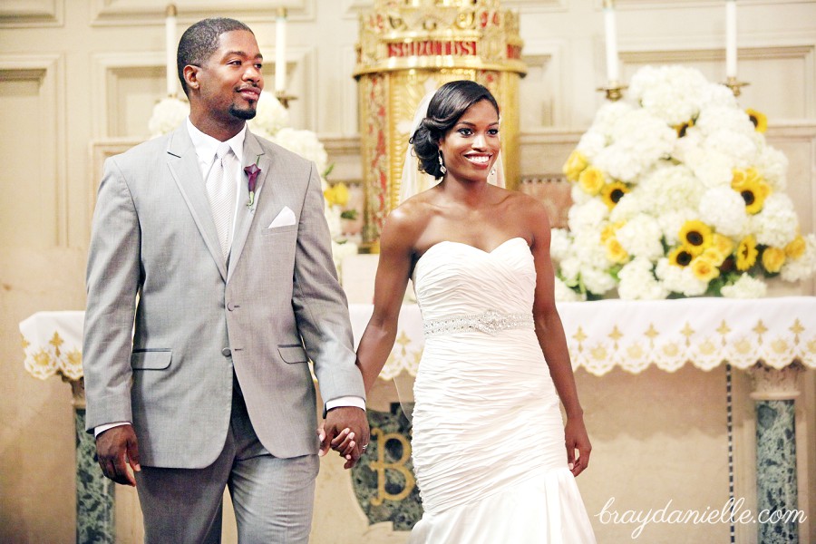 Bride and groom holding hands during ceremony