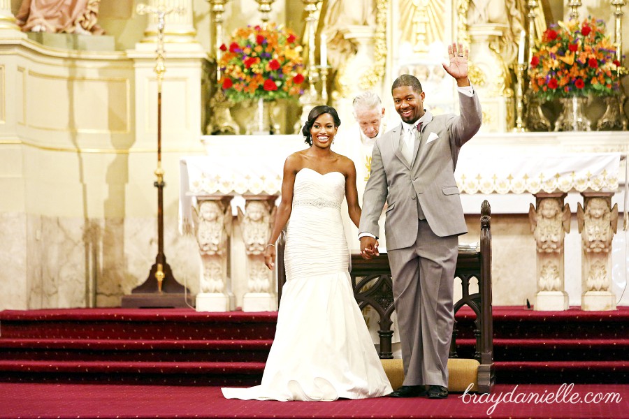 Groom waving during ceremony