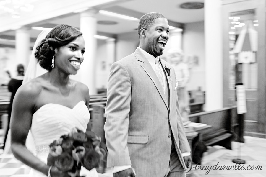 Happy bride and groom walking down the aisle