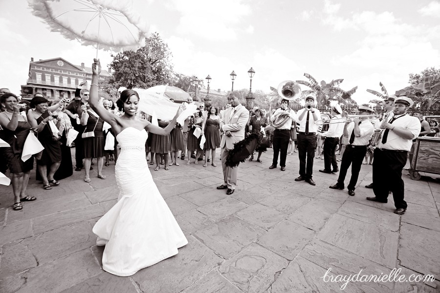 Bride and groom dancing outside with parosels