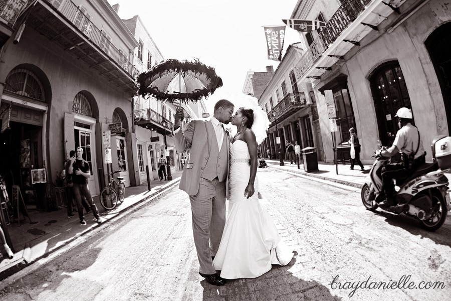 bride and groom kissing on new orleans street