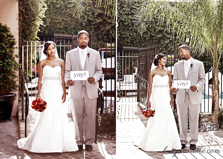 Bride and groom holding up sign