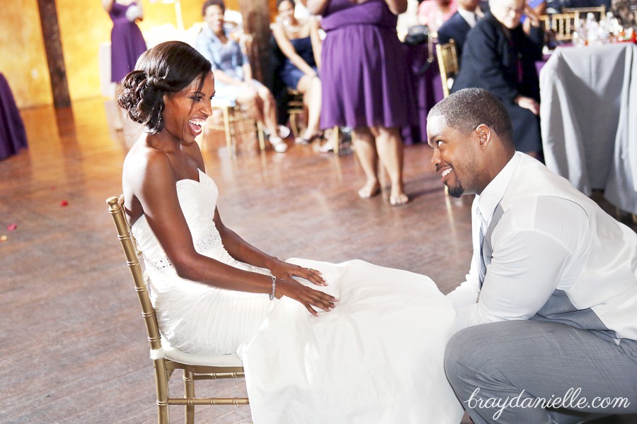 Groom reaching for garter