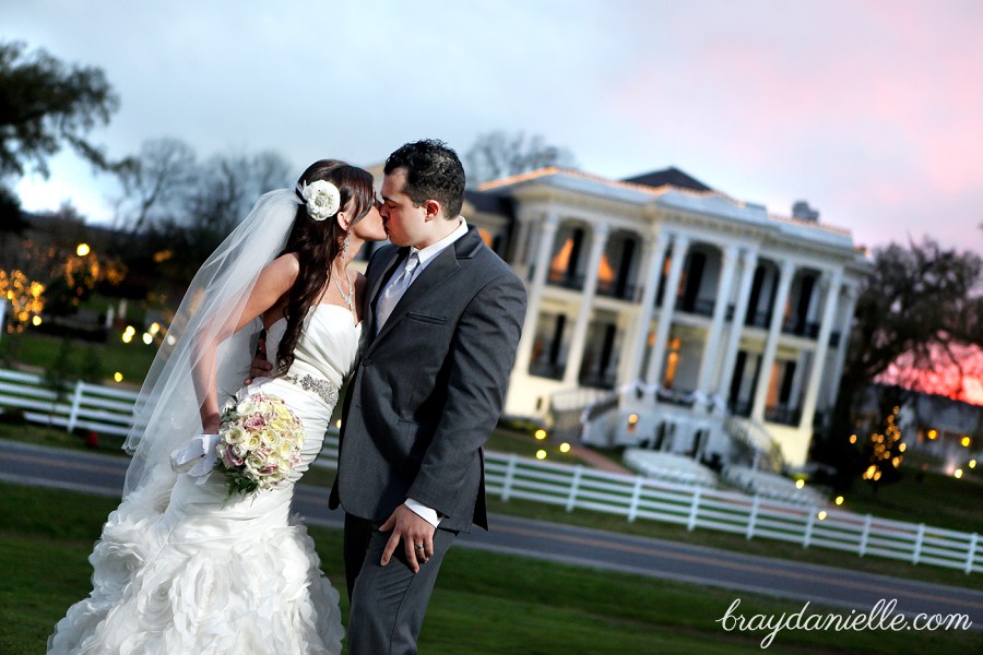 bride and groom kissing outside