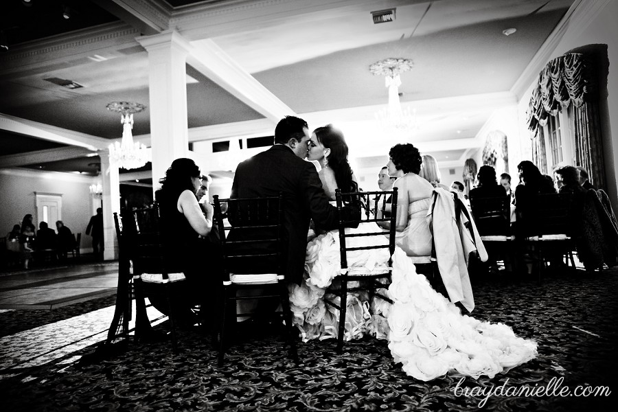 bride and groom kissing while seated